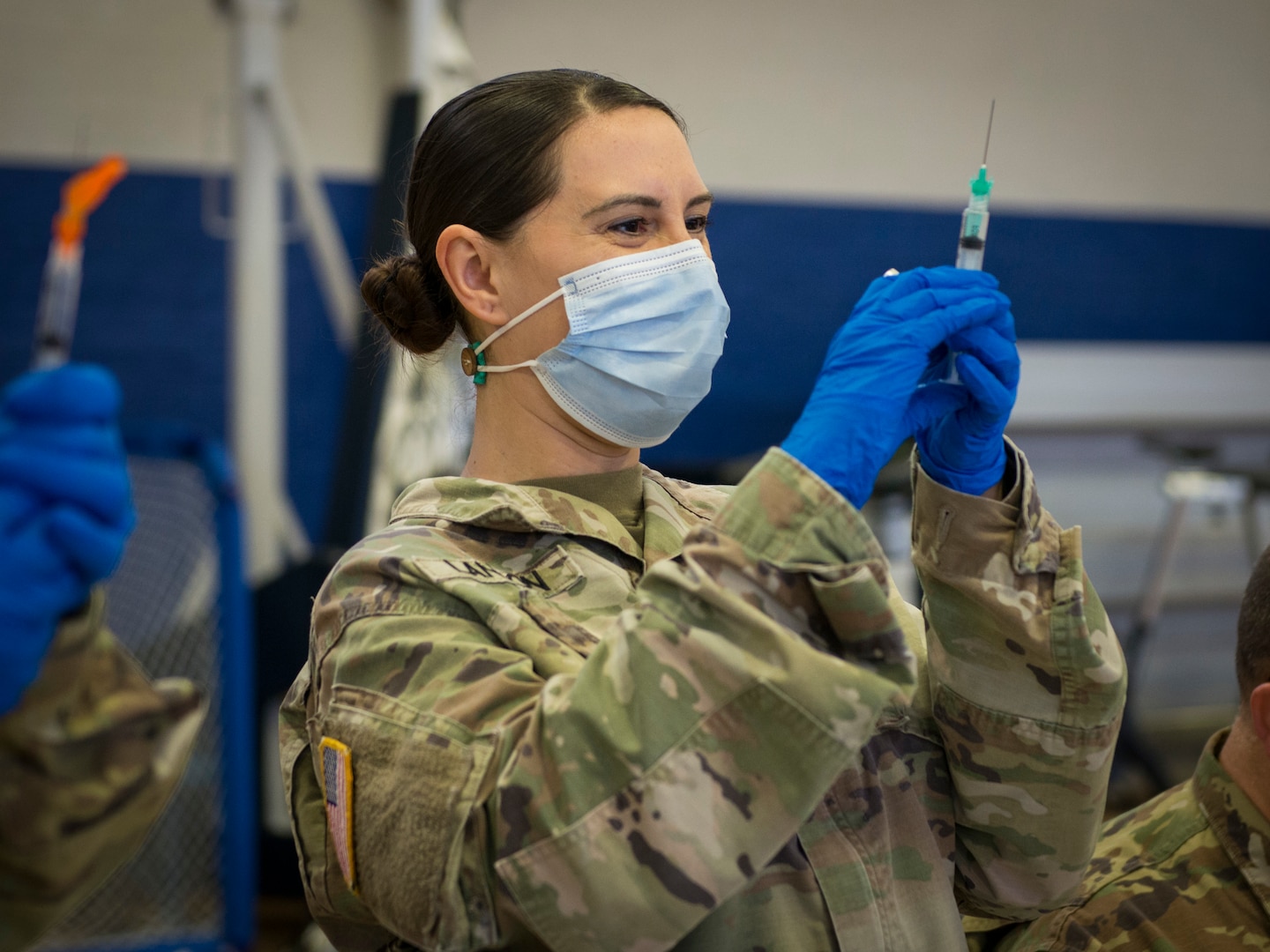 Sgt. 1st Class Sara Landon, Connecticut Army National Guard Medical Detachment readiness noncommissioned officer, prepares vials of Pfizer COVID-19 vaccine during a vaccination clinic at Naval Submarine Base New London in Groton, Connecticut, April 1, 2021. The Connecticut National Guard partnered with the base to distribute vaccines to approximately 1,000 Sailors and eligible Navy personnel.