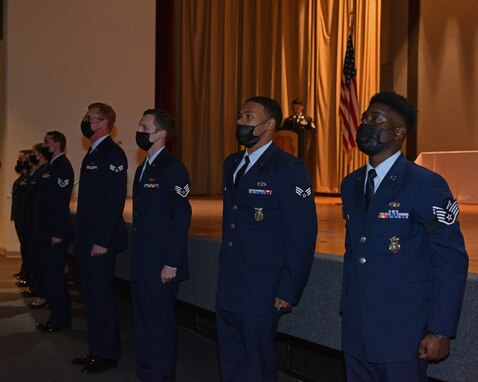 Graduates of Airman Leadership School Class 21-C prepare to sing the Air Force Song during the ALS Graduation ceremony in the Base Theater on Goodfellow Air Force Base, Texas, April 1, 2021. The graduation of ALS marks completion of the first enlisted professional military education course. (U.S. Air Force photo by Senior Airman Ashley Thrash)