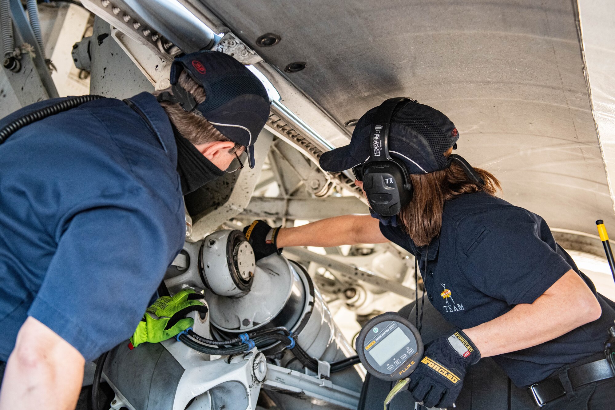 From left, Tara Pope, 97th Aircraft Maintenance Squadron C-17 Globemaster III crew chief, and Jennifer Cortez, 97th MXG C-17 aircraft attendant, conduct a check on the landing gear struts of a C-17, March 10, 2021, at Altus Air Force Base, Oklahoma. On a yearly basis, maintainers from all three airframes help support more than 5,000 sorties and 23,000 flying hours for the next generation of mobility Airmen. (U.S. Air Force photo by Senior Airman Breanna Klemm)