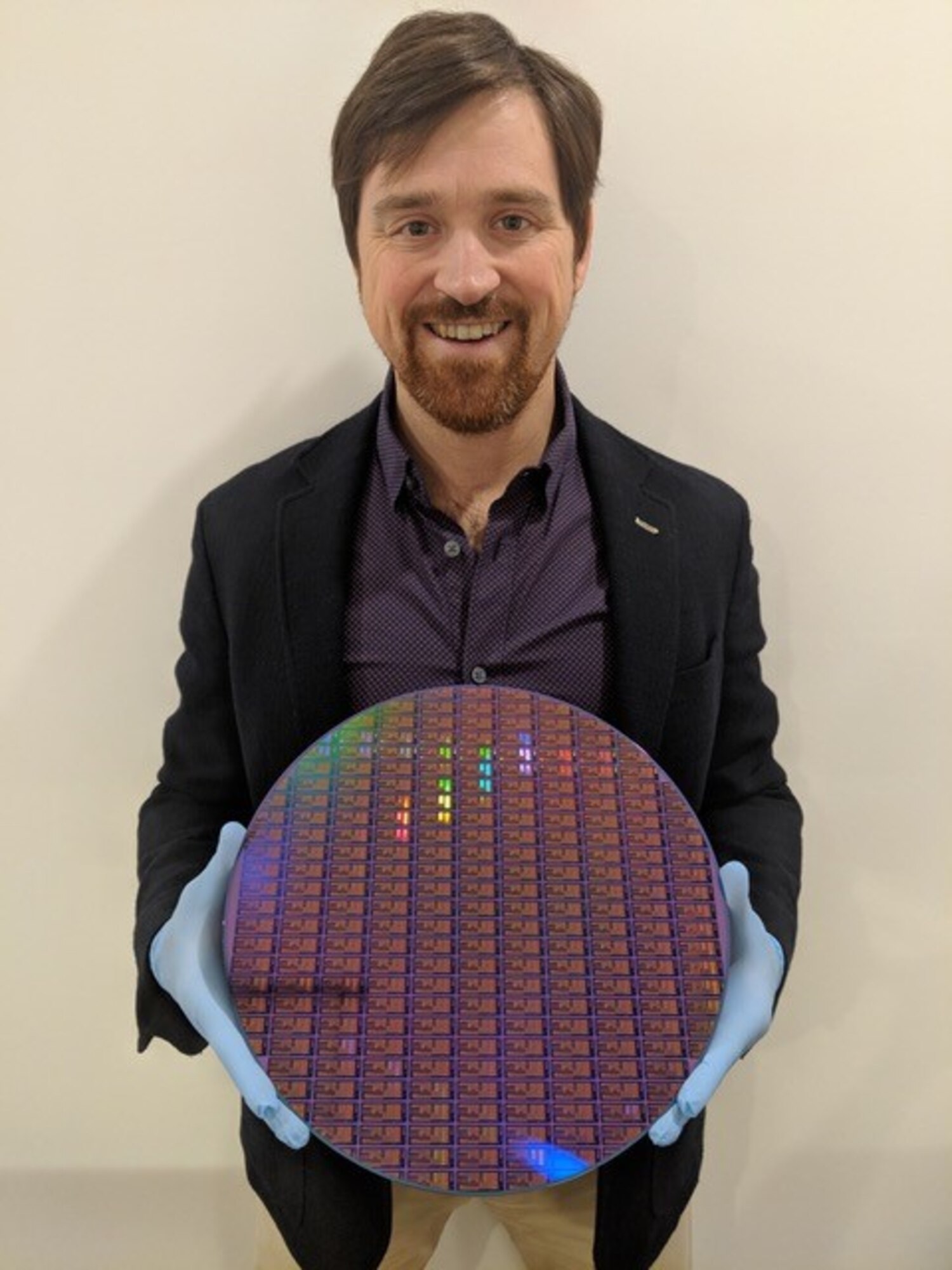 Dr. Chad Husko, CEO and founder of Iris Light, holds a 300 mm silicon wafer. (Courtesy photo)