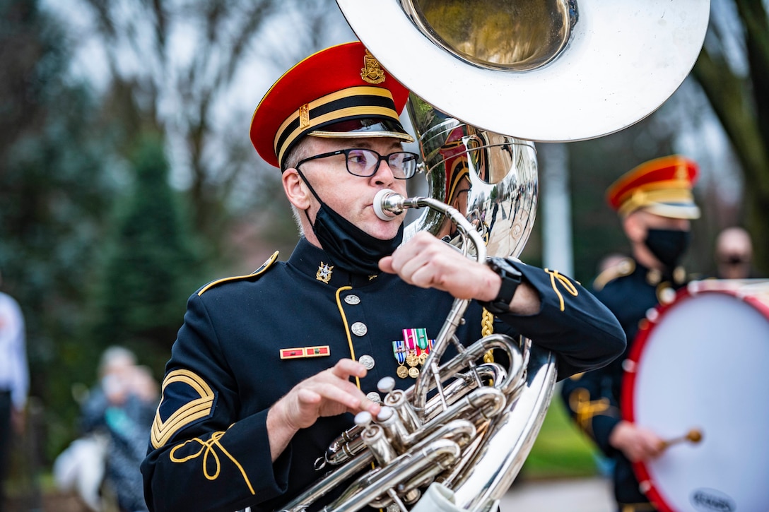 A soldier plays an instrument.