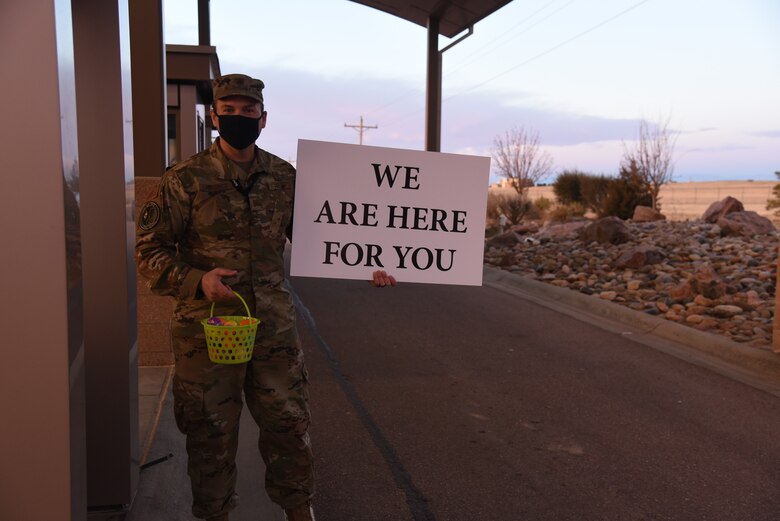 Schriever Air Force Base Chaplain (Capt.) Ronald Lawrence Jr., hands out Easter eggs to Airmen and Guardians as they arrive at Enoch Gate, April 2, 2021. The chapel ministry team is committed to serving the spiritual readiness of the Peterson-Schriever Garrison community. (U.S. Space Force photo by Airman 1st Class Brooke Wise)