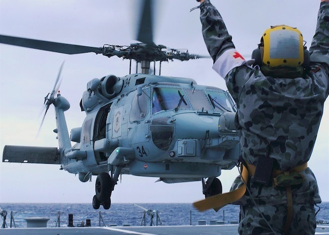 Australian sailors launch Sea Hawk helicopters aboard USS John Finn