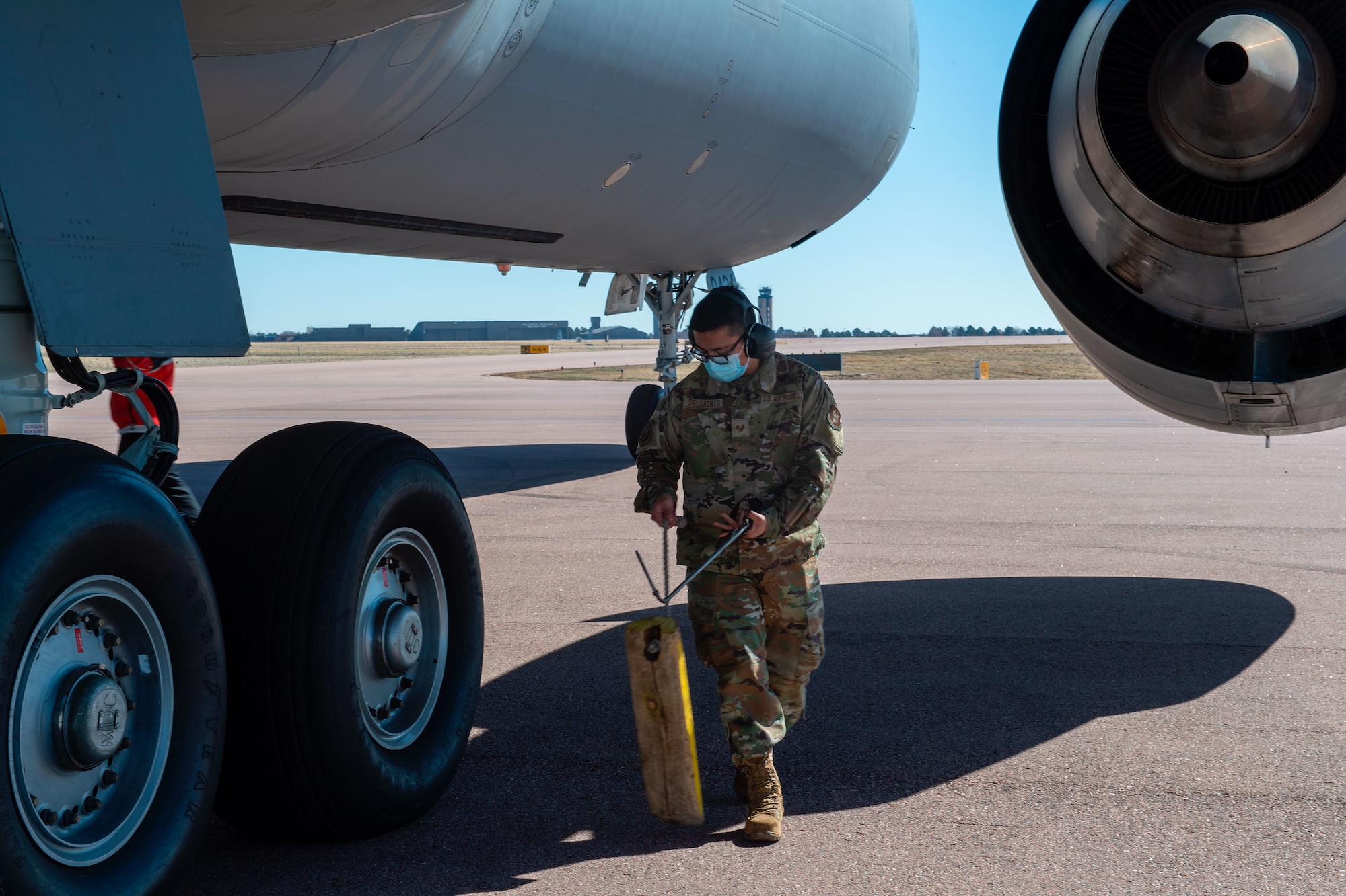 U.S. Air Force Staff Sgt. Angel Delgadillo, a communications navigation technician with the 714th Aircraft Maintenance Squadron, pulls chalks prior to a flight from Colorado to Joint Base McGuire-Dix-Lakehurst, New Jersey. Reservists with the 514th AMW fly and maintain both KC-10 Extenders and C-17 Globemaster IIIs. (U.S. Air Force photo by Tech. Sgt. Monica Ricci)