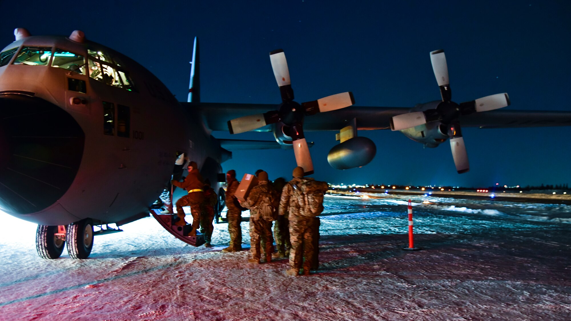 U.S. Air Force Airmen from the 148th Fighter Wing step onto a C-130 in Yellowknife, Canada preparing to forward-deploy in the early morning hours during North American Aerospace Defense Command’s Arctic air defense exercise, Amalgam Dart 21-2, March 22, 2021. The exercise will run from March 20-26 and range from the Beaufort Sea to Thule, Greenland and extend south down the Eastern Atlantic to the U.S. coast of Maine.