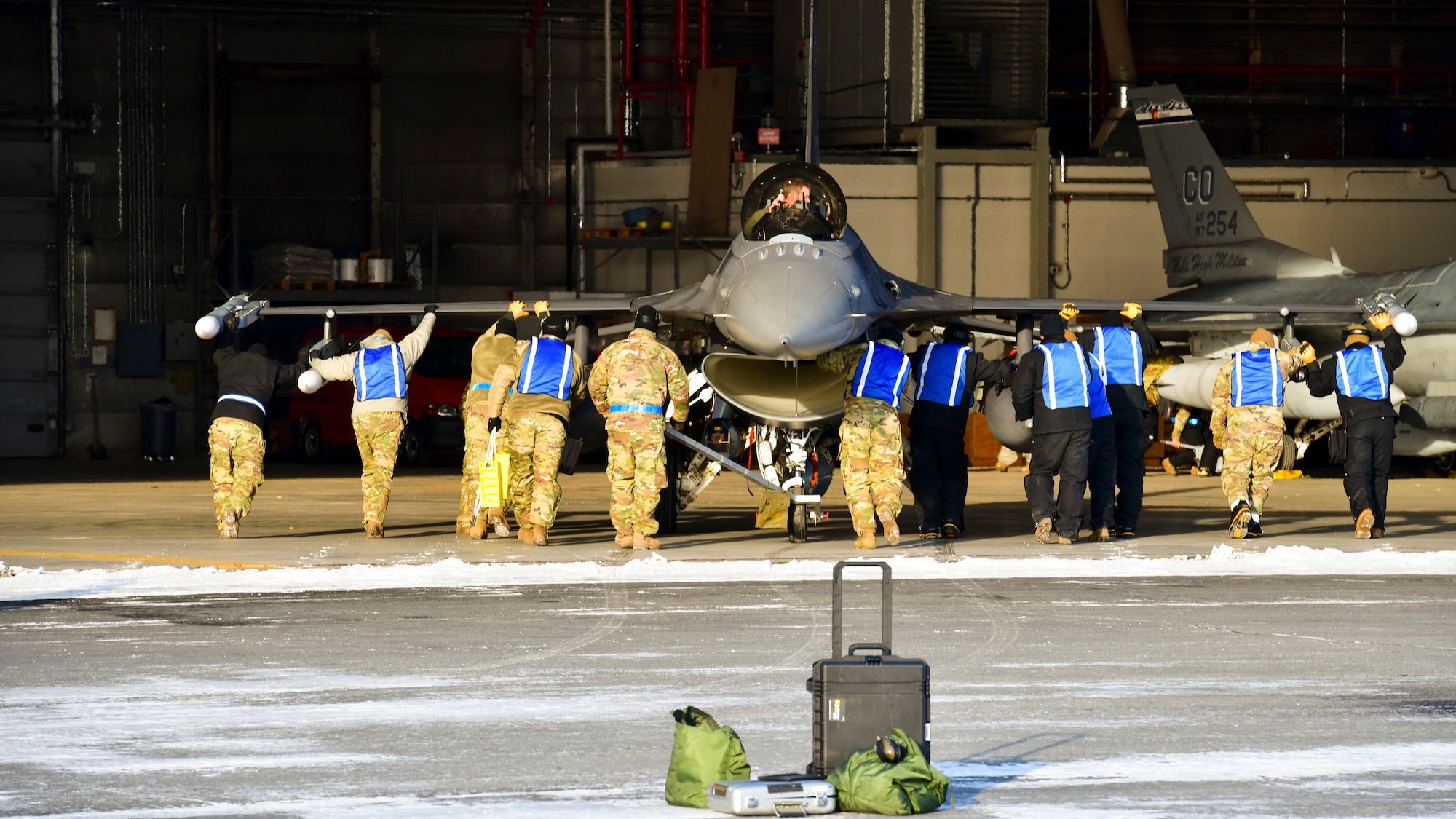 U.S. Air Force Airmen from the 148th Aircraft Maintenance Squadron recover an F-16 at Thule Air Base, Greenland during North American Aerospace Defense Command’s Arctic air defense exercise, Amalgam Dart 21-02, March 22, 2021.