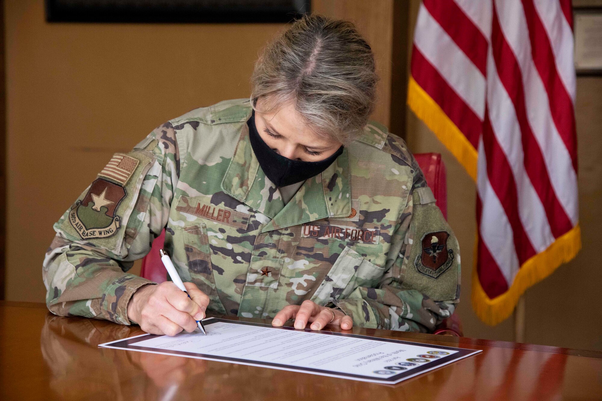 Brig. Gen. Caroline M. Miller, 502d Air Base Wing and Joint Base San Antonio commander, signs the Month of the Military Child proclamation April 1, 2021, at JBSA-Fort Sam Houston.