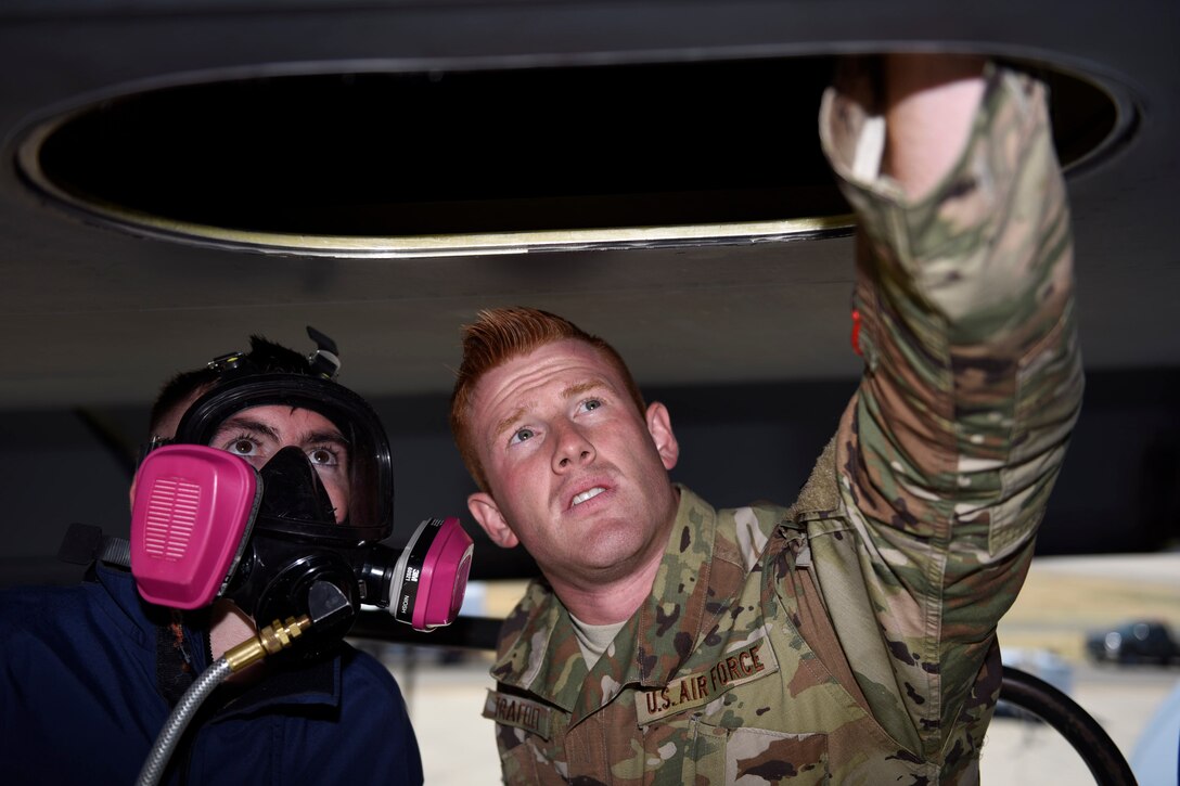 U.S. Air Force Airman 1st Class Samuel Lansky, left, 60th Maintenance Squadron fuel systems technician, and Senior Airman Zachery Trafelet, 60th MXS fuel systems technician, inspect the fuel tank inside the wing of a C-5M Super Galaxy June 23, 2020, at Travis Air Force Base, California. The 60th MXS fuel shop maintains the fuel systems for all aircraft assigned to Travis AFB, home to the largest air mobility wing in the Air Force.  (U.S. Air Force photo by Airman 1st Class Cameron Otte)