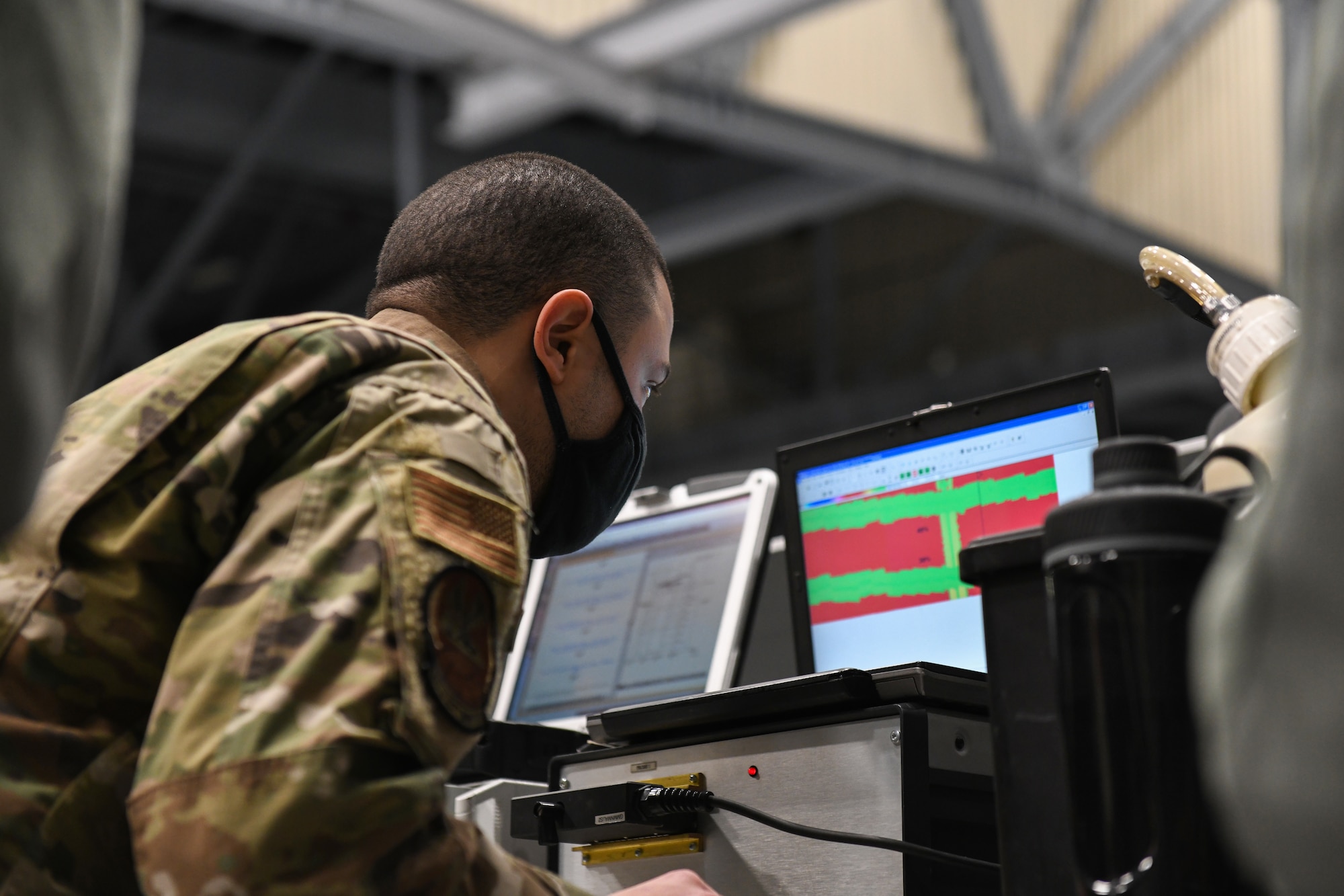 Senior Airman Harry Fraticelli, 319th Aircraft Maintenance Squadron nondestructive inspection craftsman, checks for cracks and defects on an RQ-4 Global Hawk using the image produced from a mobile automated scanner system on Grand Forks Air Force Base, N.D., March 25, 2021. Fraticelli has trained multiple Airmen in the 319 AMXS NDI shop to be certified to lead a MAUS inspection on the RQ-4 Global Hawk. (U.S. Air Force photo by Airman 1st Class Ashley Richards)