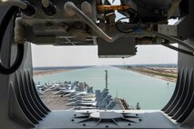 210402-N-MD713-2012 SUEZ CANAL (April 2, 2021) The aircraft carrier USS Dwight D. Eisenhower (CVN 69) transits the Suez Canal, April 2. The Eisenhower Carrier Strike Group is deployed to the U.S. 5th Fleet area of operations in support of naval operations to ensure maritime stability and security in the Central Region, connecting the Mediterranean and Pacific through the Western Indian Ocean and three strategic choke points. (U.S. Navy photo by Mass Communication Specialist 3rd Class Cameron Pinske)