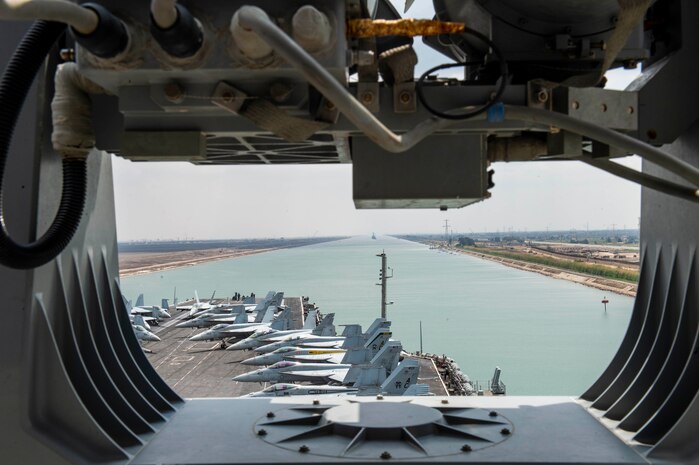 210402-N-MD713-2012 SUEZ CANAL (April 2, 2021) The aircraft carrier USS Dwight D. Eisenhower (CVN 69) transits the Suez Canal, April 2. The Eisenhower Carrier Strike Group is deployed to the U.S. 5th Fleet area of operations in support of naval operations to ensure maritime stability and security in the Central Region, connecting the Mediterranean and Pacific through the Western Indian Ocean and three strategic choke points. (U.S. Navy photo by Mass Communication Specialist 3rd Class Cameron Pinske)