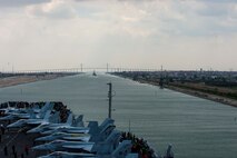 210402-N-MD713-2041 SUEZ CANAL (April 2, 2021) The aircraft carrier USS Dwight D. Eisenhower (CVN 69) and guided-missile destroyer USS Mitscher (DDG 57) approach the Friendship Bridge during a Suez Canal transit, April 2. The IKE Carrier Strike Group is deployed to the U.S. 5th Fleet area of operations in support of naval operations to ensure maritime stability and security in the Central Region, connecting the Mediterranean and Pacific through the Western Indian Ocean and three strategic choke points. (U.S. Navy photo by Mass Communication Specialist 3rd Class Cameron Pinske/Released)