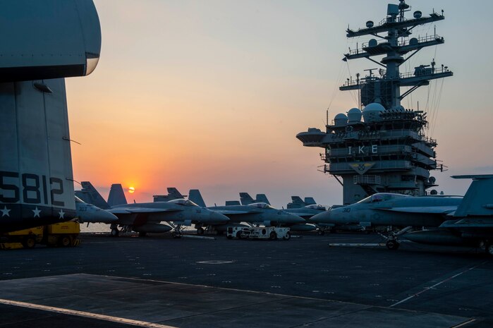 210402-N-MW930-1011 SUEZ CANAL (April 2, 2021) The aircraft carrier USS Dwight D. Eisenhower (CVN 69) transits the Suez Canal, April 2. The Eisenhower Carrier Strike Group is deployed  to the U.S. 5th Fleet area of operations in support of naval operations to ensure maritime stability and security in the Central Region, connecting the Mediterranean and Pacific through the Western Indian Ocean and three strategic choke points. (U.S. Navy photo by Mass Communication Specialist Seaman Eric Edinger)