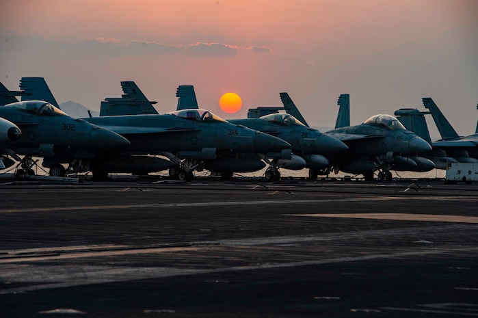 210402-N-MY760-1070 SUEZ CANAL (April 2, 2021) The aircraft carrier USS Dwight D. Eisenhower (CVN 69) transits the Suez Canal, April 2. The Eisenhower Carrier Strike Group is deployed to the U.S. 5th Fleet area of operations in support of naval operations to ensure maritime stability and security in the Central Region, connecting the Mediterranean and Pacific through the Western Indian Ocean and three strategic choke points. (U.S. Navy photo by Mass Communications Specialist 3rd Class Joseph T. Miller)