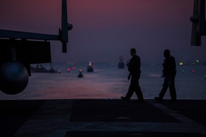 210402-N-OB471-2060 SUEZ CANAL (April 2, 2021) Master-at-Arms 1st Class Andrew Eickholt, left, and Airman Edwin Rivera stand security watch on the flight deck as the aircraft carrier USS Dwight D. Eisenhower (CVN 69) transits the Suez Canal, April 2. The Eisenhower Carrier Strike Group is deployed to the U.S. 5th Fleet area of operations in support of naval operations to ensure maritime stability and security in the Central Region, connecting the Mediterranean and Pacific through the Western Indian Ocean and three strategic choke points. (U.S. Navy photo by Mass Communication Specialist Seaman Jacob Hilgendorf)