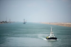 210402-N-TE455-2112 SUEZ CANAL (April 2, 2021) The guided-missile destroyer USS Thomas Hudner (DDG 116) and the guided-missile cruiser USS Monterey (CG 61) sail behind the aircraft carrier USS Dwight D. Eisenhower (CVN 69) during a Suez Canal transit, April 2. The Eisenhower Carrier Strike Group is deployed to the U.S. 5th Fleet area of operations in support of naval operations to ensure maritime stability and security in the Central Region, connecting the Mediterranean and Pacific through the Western Indian Ocean and three strategic choke points. (U.S. Navy photo by Mass Communication Specialist Seaman Apprentice Mo Bourdi)