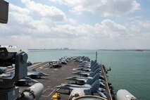 210402-N-MD713-1058 SUEZ CANAL (April 2, 2021) The aircraft carrier USS Dwight D. Eisenhower (CVN 69) transits the Suez Canal, April 2. The Eisenhower Carrier Strike Group is deployed to the U.S. 5th Fleet area of operations in support of naval operations to ensure maritime stability and security in the Central Region, connecting the Mediterranean and Pacific through the Western Indian Ocean and three strategic choke points. (U.S. Navy photo by Mass Communication Specialist 3rd Class Cameron Pinske)