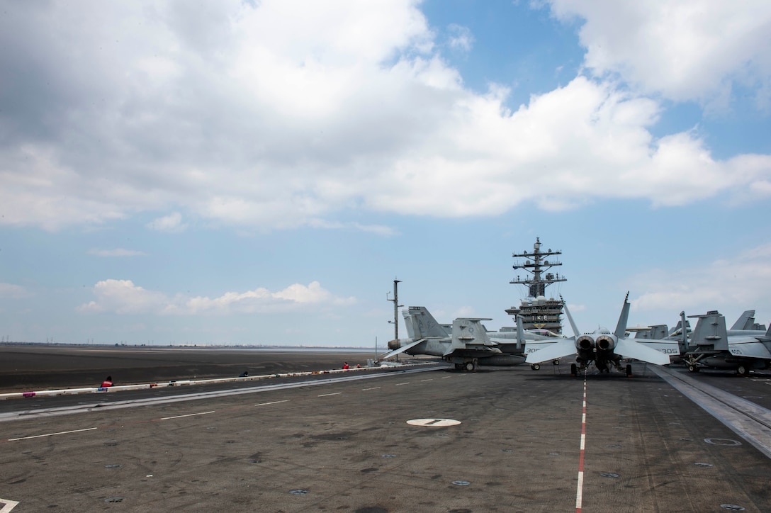 210402-N-OC881-1043 SUEZ CANAL (April 2, 2021) The aircraft carrier USS Dwight D. Eisenhower (CVN 69) transits the Suez Canal, April 2. The Eisenhower Carrier Strike Group is deployed    to the U.S. 5th Fleet area of operations in support of naval operations to ensure maritime stability and security in the Central Region, connecting the Mediterranean and Pacific through the Western Indian Ocean and three strategic choke points. (U.S. Navy photo by Mass Communication Specialist 3rd Class Conner Houghtaling)