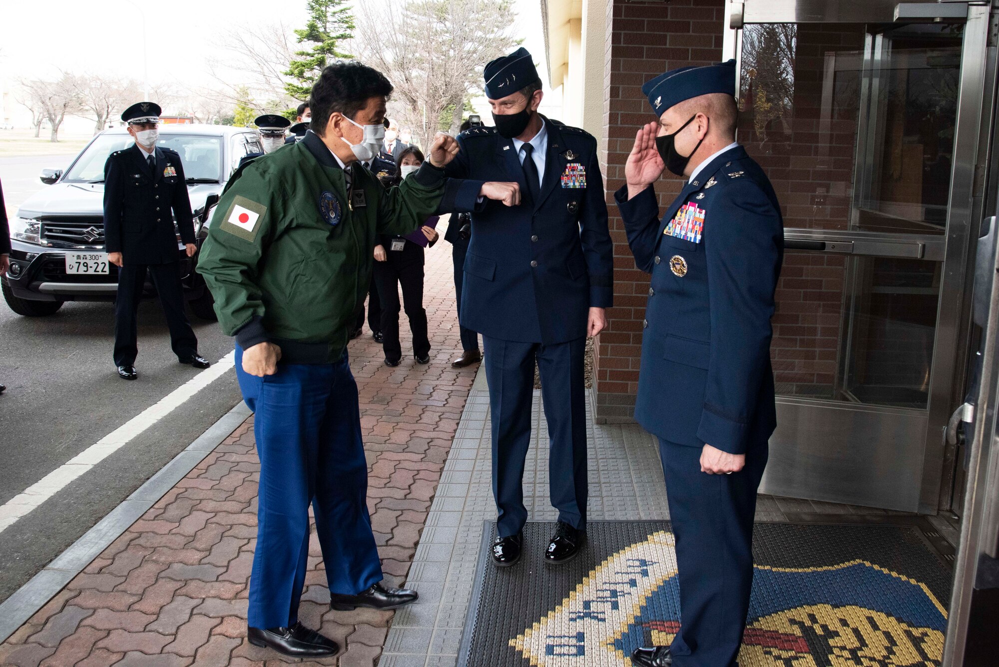 Japan Minister of Defense, Nobuo Kishi, is greeted by Lt. Gen. Kevin Schneider, U.S. Forces Japan and 5th Air Force commander, and saluted by Col. Jesse Friedel, 35th Fighter Wing commander, during a visit at Misawa Air Base on April 3, 2021. During the visit, Minister of Defense Kishi received briefings about the F-16 Fighting Falcon, and the 35th FW’s mission to defend Japan with advanced Suppression of Enemy Air Defense and Destruction of Enemy Air Defense capabilities. SEAD and DEAD capabilities are critical to maintaining credible deterrence and defense in the Indo-Pacific region. (U.S. Air force photo by Maj. Cody Chiles)