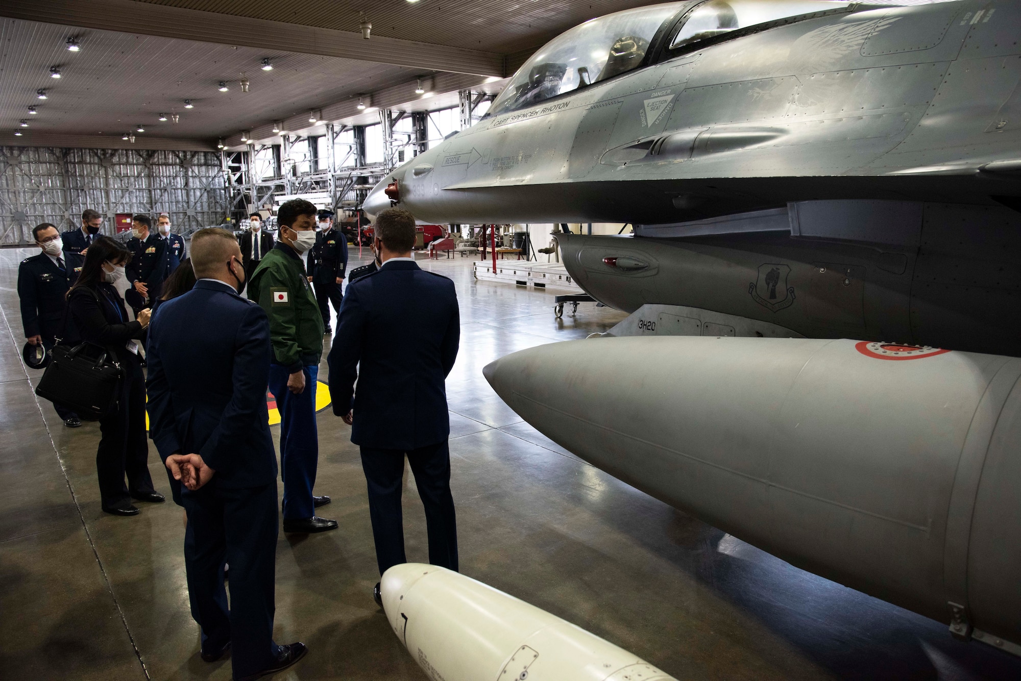 Capt. Austin Bangerter, 13th Fighter Squadron pilot, briefs Japan Minister of Defense, Nobuo Kishi, about the F-16 Fighting Falcon, and the 35th FW’s mission to defend Japan, during a visit at Misawa Air Base on April 3, 2021. During the visit senior leaders emphasized the importance of U.S. and Japanese bilateral interoperability through realistic, high quality training and operations. They also discussed the strategic importance of Misawa Air Base as the premier location for aircraft to conduct training in the Indo-Pacific region. (U.S. Air force photo by Maj. Cody Chiles)