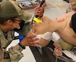Staff Sgt. Jones intubates a casualty during practical 
exercises.