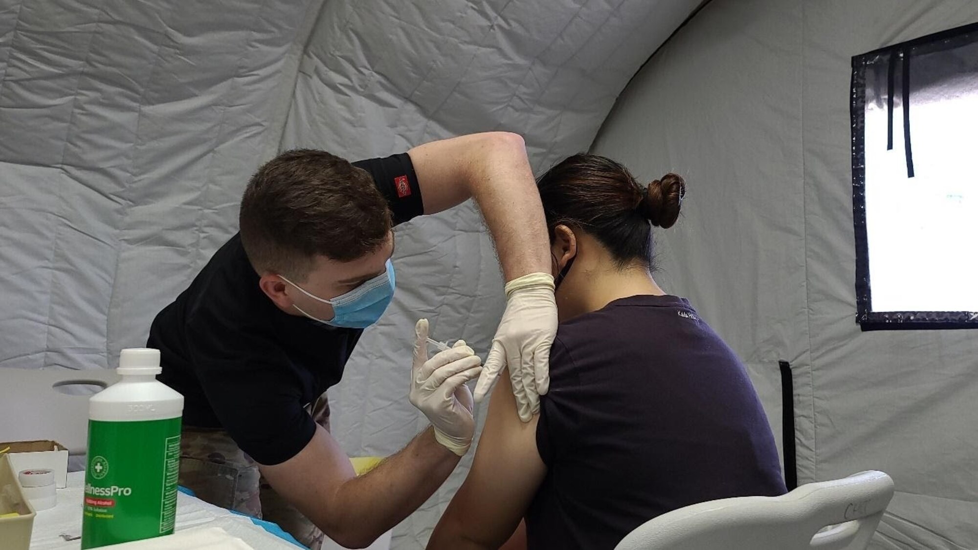 Sgt. Jarrod Clements, assigned to 25th Infantry Division, administers a COVID-19 Vaccine in support of the Commonwealth Healthcare Corporation (CHCC) COVID-19 Vaccination team at the Medical Care and Treatment Site (MCATS).