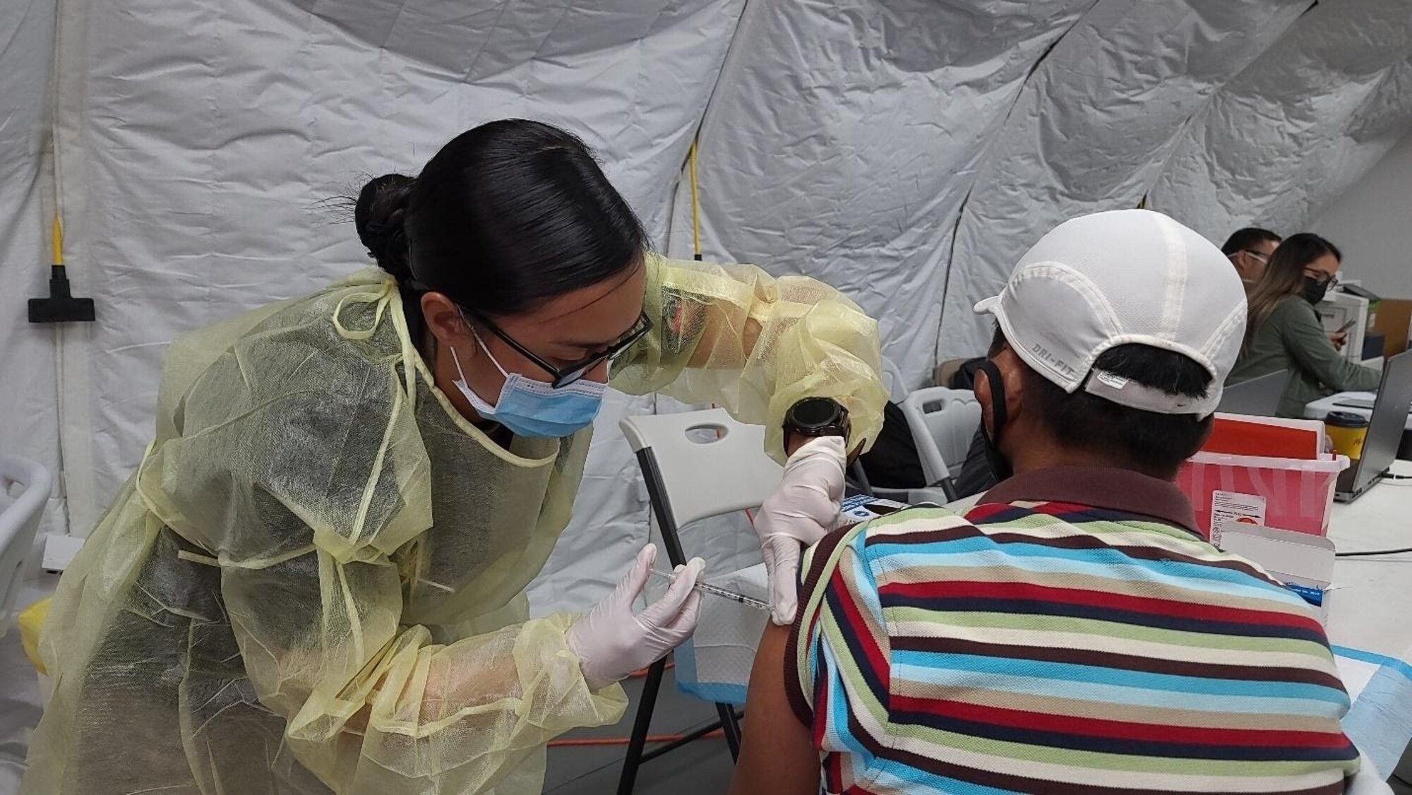 Sgt. Franchesca Esteban,  assigned to 25th Infantry Division, administers a COVID-19 Vaccine in support of the Commonwealth Healthcare Corporation (CHCC) COVID-19 Vaccination team at the Medical Care and Treatment Site (MCATS).