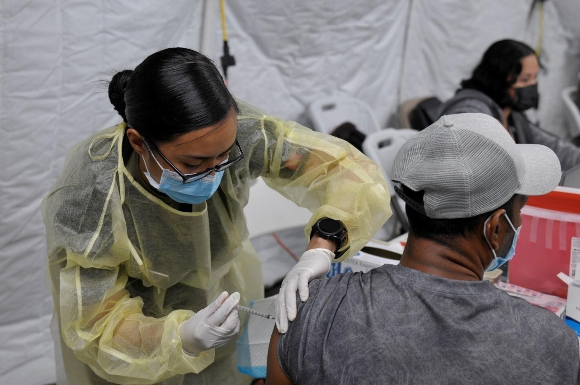 Sgt. Franchesca Esteban, assigned to 25th Infantry Division, administers a COVID-19 Vaccine in support of the Commonwealth Healthcare Corporation (CHCC) COVID-19 Vaccination team at the Medical Care and Treatment Site (MCATS).