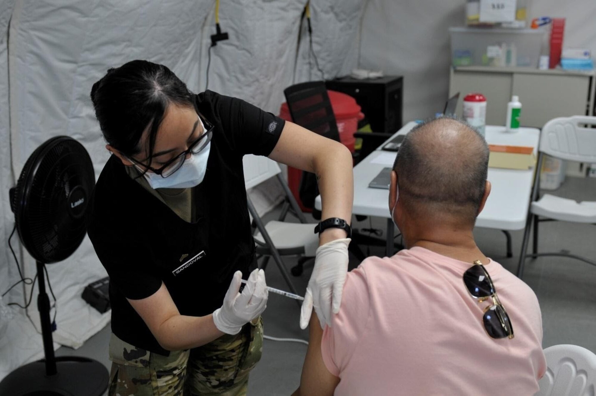 Sgt. Diana Sandoval, assigned to 25th Infantry Division, administers a COVID-19 Vaccine in support of the Commonwealth Healthcare Corporation (CHCC) COVID-19 Vaccination team at the Medical Care and Treatment Site (MCATS).
