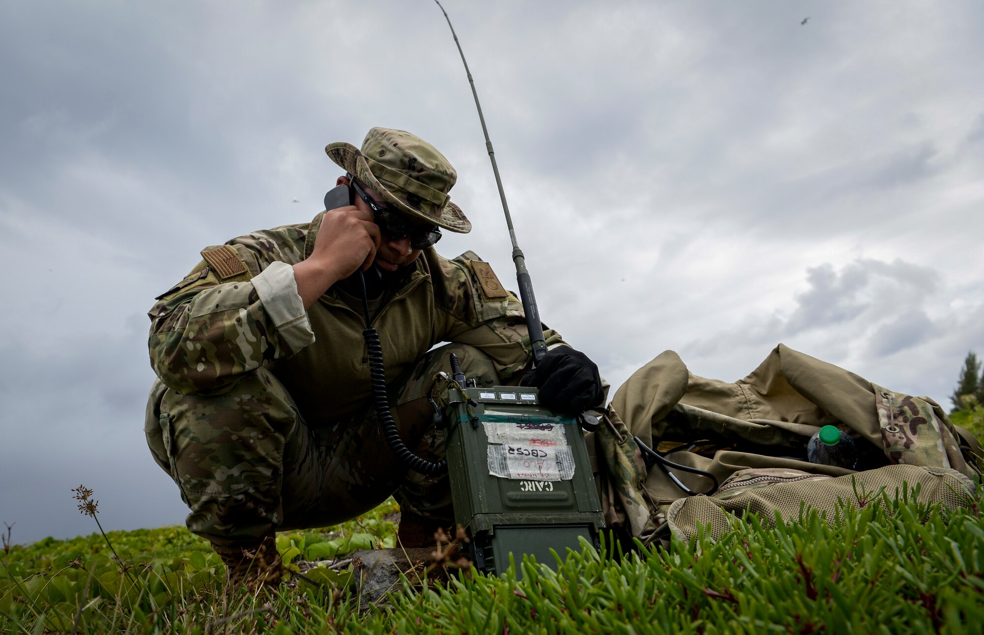 U.S. Air Force Airman 1st Class Brayan Rivera-Donalds, radio frequency transmission systems technician assigned to the 644th Combat Communications Squadron, checks the communication signal to the aircrew during a field training exercise on Wake Island, Western Pacific, April 2, 2021.