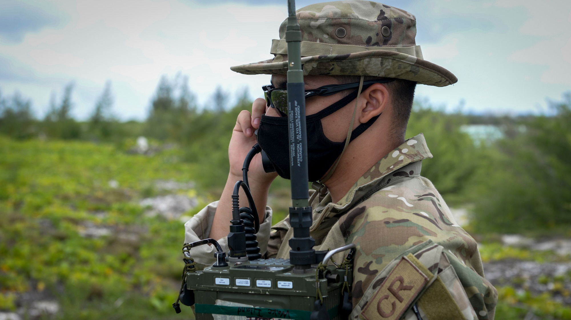 U.S. Air Force Airman 1st Class Brayan Rivera-Donalds, radio frequency transmission systems technician assigned to the 644th Combat Communications Squadron, checks the communication signal to the aircrew during a field training exercise on Wake Island, Western Pacific, April 2, 2021.
