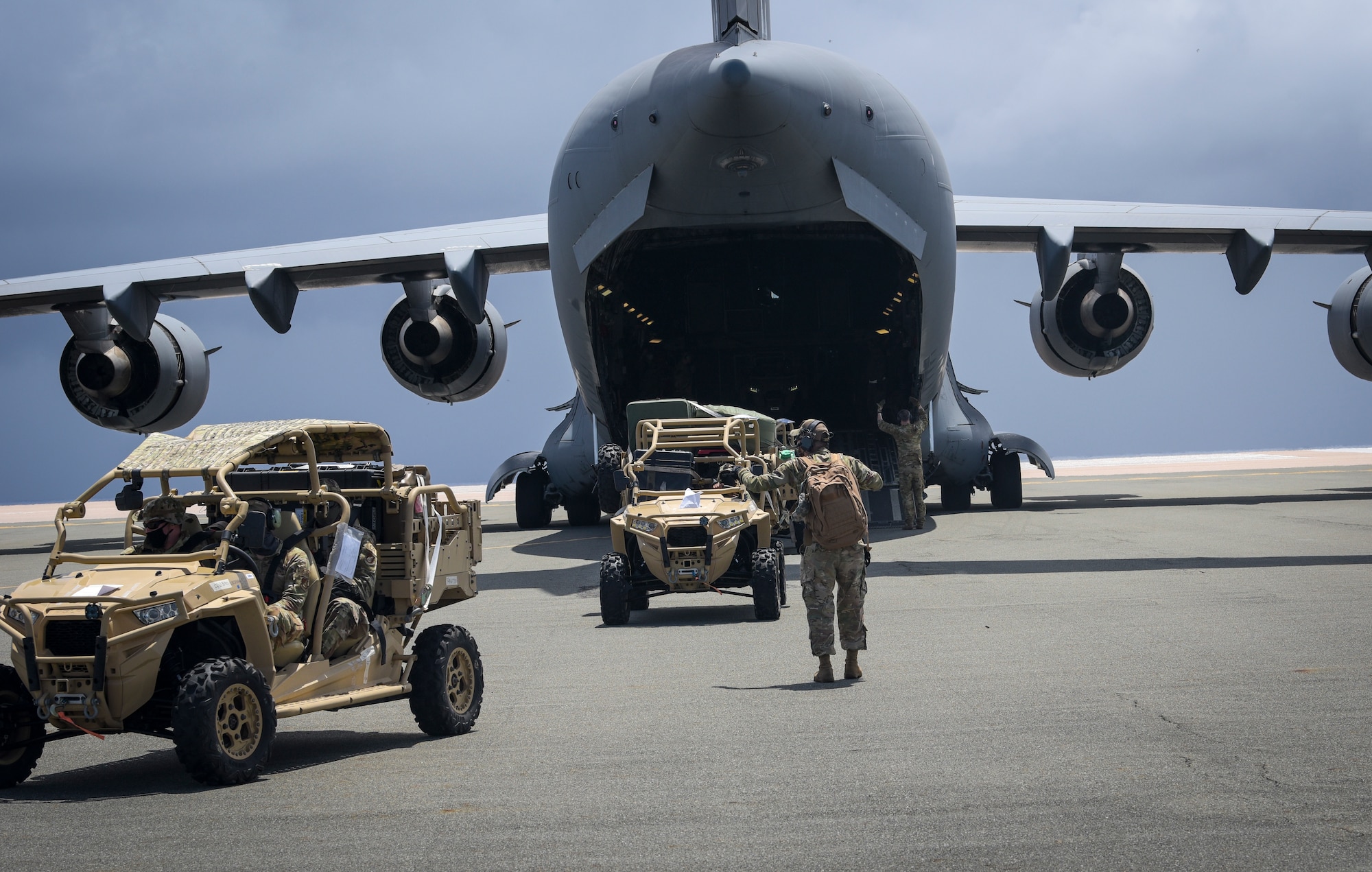 U.S. Air Force Airmen assigned to the 36th Contingency Response Group, prepare to off load a C-17 Globemaster III assigned to the 8th Airlift Squadron, McChord Air Force Base, Wash. during a field training exercise on Wake Island, Western Pacific, April 2, 2021.