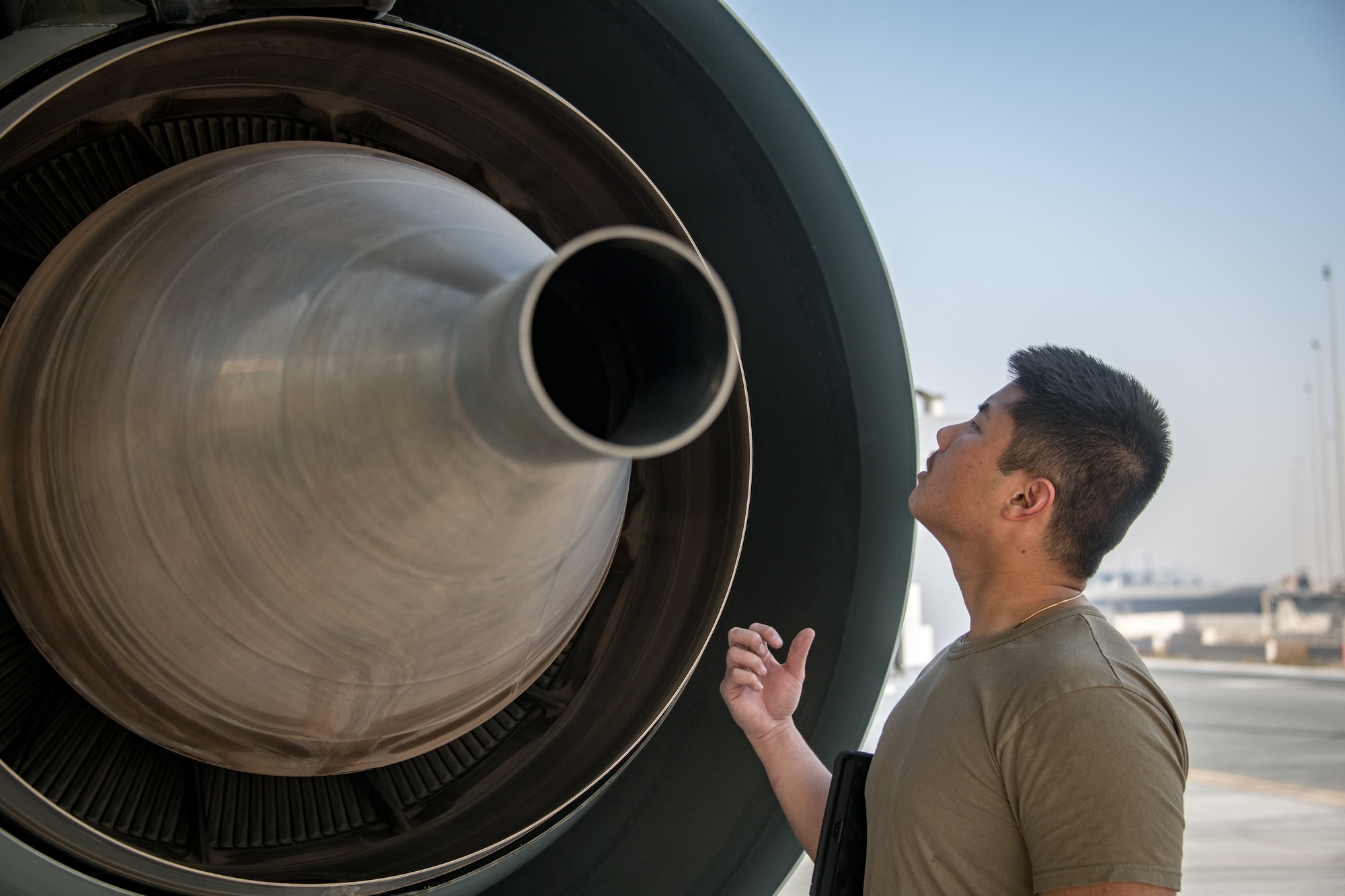 A man inspects the engine of an RC-135 Rivet Joint aircraft