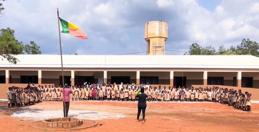 Dozens of students pose in front of a recently completed school facility in Kpomasse, Benin in Africa. The school is one of three school projects in the country recently constructed by the U.S. Army Corps of Engineers, Europe District. The U.S. Army Corps of Engineers, Europe District manages the constructions of Humanitarian Assistance projects like this one and others in Benin and in several other countries throughout Africa in support of AFRICOM and coordinated closely with the U.S. State Department.