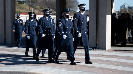 United States Honor Guard Pallbearers march in formation as part of modified military funeral honors with funeral escort for U.S. Air Force Lt. Col. Bruce Burns in Section 82 of Arlington National Cemetery, Arlington, Virginia, March 22, 2021. Burns served in the Air Force from 1962 to 1982. His spouse, Janet Burns, received the flag from his service. The funeral was an historic occasion for the United States Honor Guard, with the largest female presence on a pallbearers team in Air Force history. (U.S. Air Force photo by Staff Sgt. Stuart Bright)