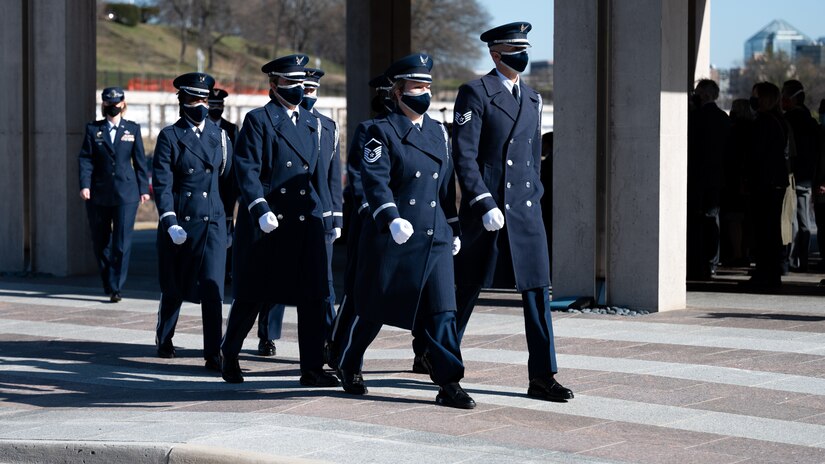 United States Honor Guard Pallbearers march in formation as part of modified military funeral honors with funeral escort for U.S. Air Force Lt. Col. Bruce Burns in Section 82 of Arlington National Cemetery, Arlington, Virginia, March 22, 2021. Burns served in the Air Force from 1962 to 1982. His spouse, Janet Burns, received the flag from his service. The funeral was an historic occasion for the United States Honor Guard, with the largest female presence on a pallbearers team in Air Force history. (U.S. Air Force photo by Staff Sgt. Stuart Bright)