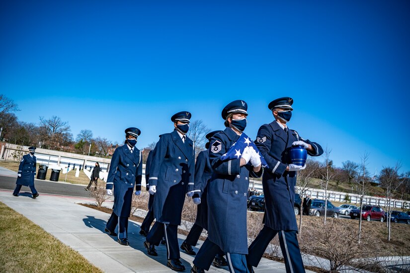 Master Sgt. Kierston Mair, flight chief, pallbearers, carries a flag with the United States Honor Guard Pallbearers as part of modified military funeral honors with funeral escort for U.S. Air Force Lt. Col. Bruce Burns in Section 82 of Arlington National Cemetery, Arlington, Virginia, March 22, 2021. Burns served in the Air Force from 1962 to 1982. His spouse, Janet Burns, received the flag from his service. The funeral was an historic occasion for the United States Honor Guard, with the largest female presence on a pallbearers team in Air Force history. 
(U.S. Army photo by Elizabeth Fraser)