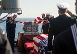 PACIFIC OCEAN (March 29, 2021) Sailors fold the national ensign during a burial at sea ceremony aboard the Wasp-class amphibious assault ship USS Essex (LHD 2). Essex is underway conducting routine operations in U.S. 3rd Fleet. (U.S. Navy photo by Mass Communication Specialist 3rd Class Brett McMinoway)