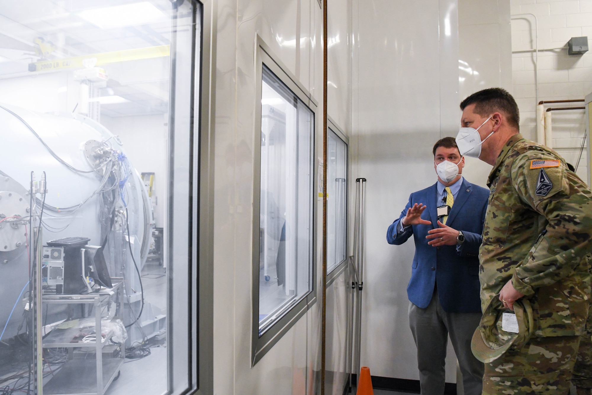 Gen. David Thompson, right, vice chief of space operations, U.S. Space Force, looks at the 7V Space Environmental Chamber as John Claybrook, capability manager for the Arnold Engineering Development Complex Space Asset Resilience Ground Test and Evaluation, briefs him about the capability at Arnold Air Force Base, Tenn., headquarters of AEDC, Feb. 5, 2021.  (U.S. Air Force photo by Jill Pickett) (This image was altered by obscuring badges for security purposes.)