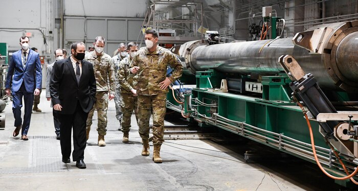 Jonathan Carroll, front left, capability manager for the Arnold Engineering Development Complex Hypervelocity Flyout, Impact and Lethality Ground Test and Evaluation, briefs Gen. David Thompson, front right, vice chief of Space Operations, U.S. Space Force, about the capability as they tour Range G at Arnold Air Force Base, Tenn., headquarters of AEDC, Feb. 5, 2021. (U.S. Air Force photo by Jill Pickett) (This image was altered by obscuring badges for security purposes.)