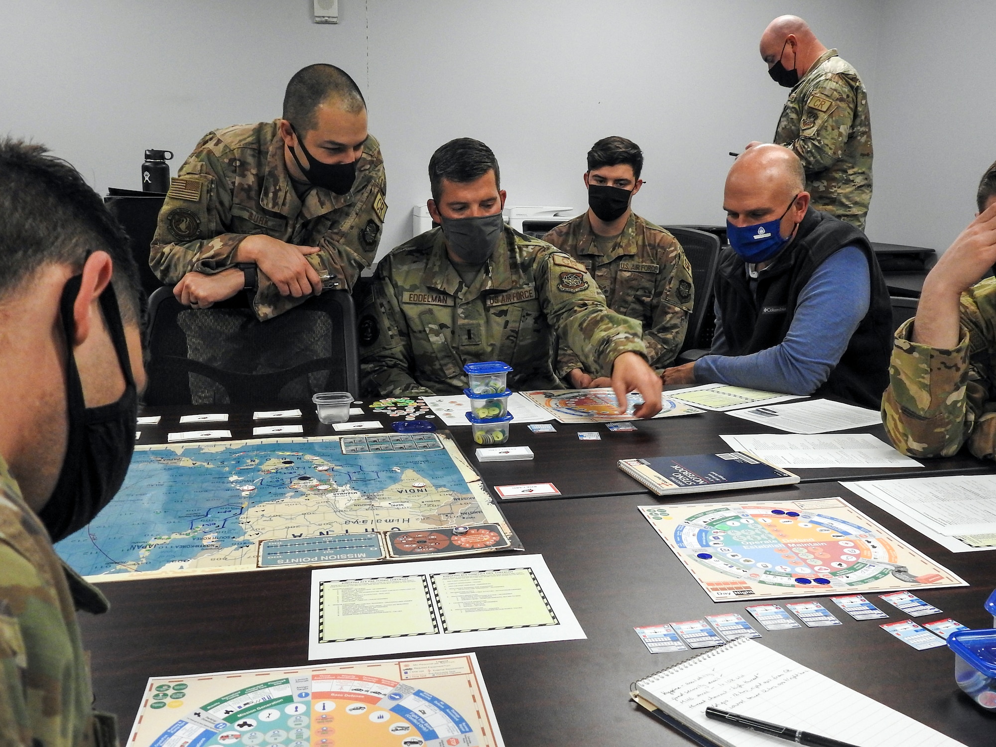 Airmen from various units within the 621st Contingency Response Wing play a prototype military strategy game March 25, 2021, at Travis Air Force Base, California. The game, called “Kingfish ACE” focuses on a hypothetical situation in the Western Pacific and is a strategy game similar to “Risk” and “Dungeons & Dragons.” (U.S. Air Force photo by Senior Airman Chad Kotce)