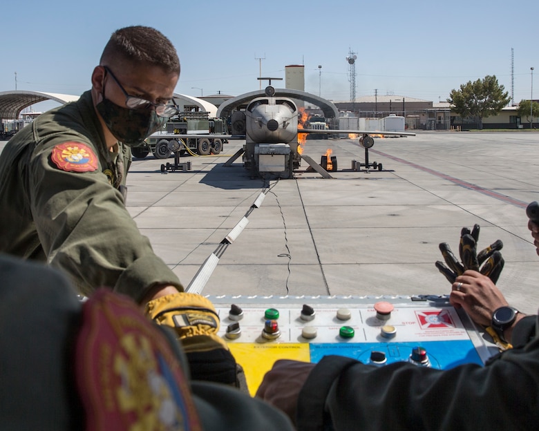 U.S. Marines with the Aircraft Rescue and Firefighting (ARFF), Headquarters and Headquarters Squadron, Marine Corps Air Station (MCAS) Yuma conduct annual training on MCAS Yuma, Ariz., Sept. 28, 2020. ARFF Marines set up a mobile aircraft fire training device to set up multiple aircraft fire scenarios to maintain operational readiness. (U.S. Marine Corps photo by Cpl. Jason Monty)