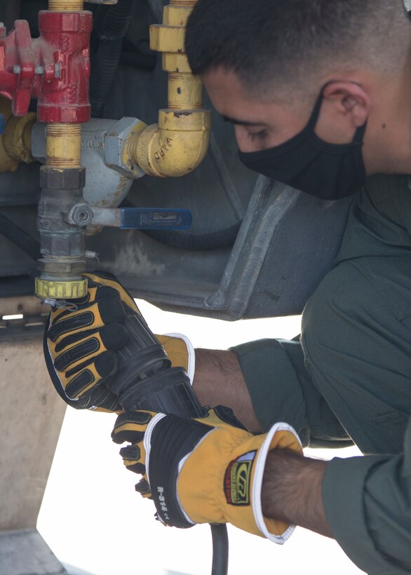 U.S. Marines with the Aircraft Rescue and Firefighting (ARFF), Headquarters and Headquarters Squadron, Marine Corps Air Station (MCAS) Yuma conduct annual training on MCAS Yuma, Ariz., Sept. 28, 2020. ARFF Marines set up a mobile aircraft fire training device to set up multiple aircraft fire scenarios to maintain operational readiness. (U.S. Marine Corps photo by Cpl. Jason Monty)