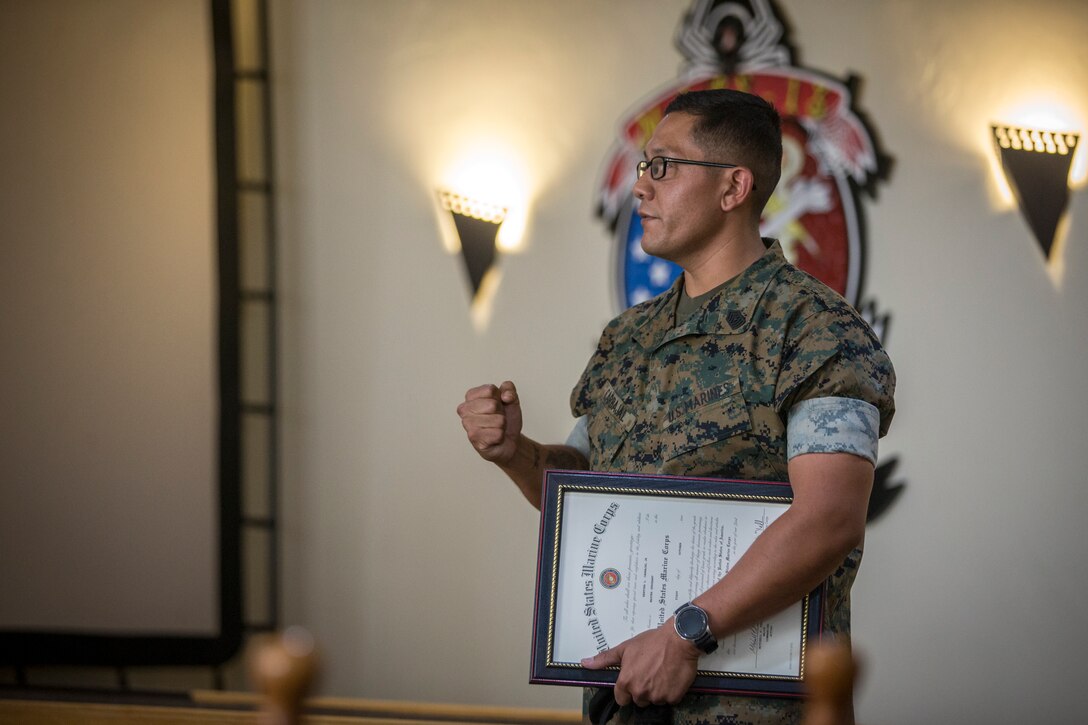 U.S. Marine Corps SgtMaj Luis Galvez, the Sergeant Major of Headquarters and Headquarters Squadron (H&HS), Marine Corps Air Station (MCAS) Yuma, reads a warrant during a promotion ceremony at MCAS Yuma, Ariz., Oct. 1, 2020.