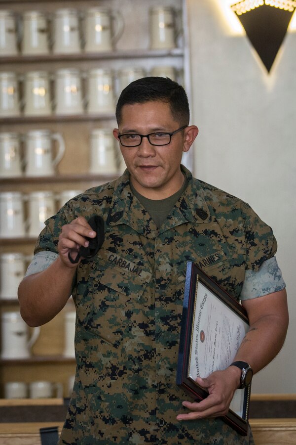 U.S. Marine Corps SgtMaj Luis Galvez, the Sergeant Major of Headquarters and Headquarters Squadron (H&HS), Marine Corps Air Station (MCAS) Yuma, reads a warrant during a promotion ceremony at MCAS Yuma, Ariz., Oct. 1, 2020.