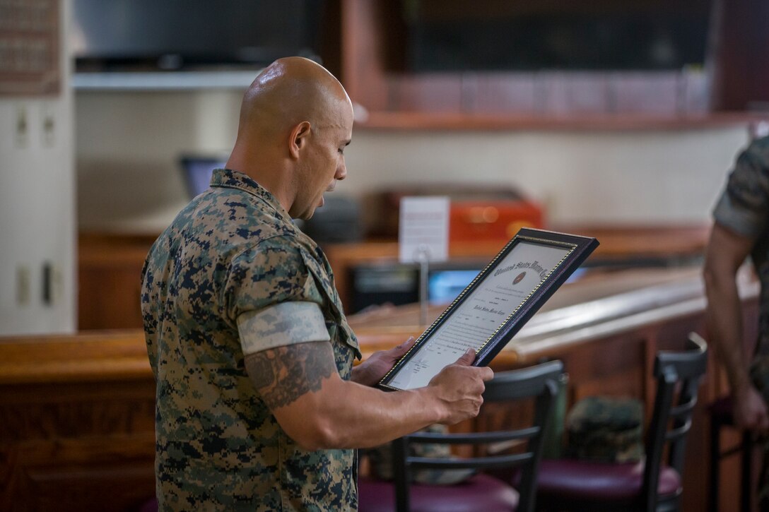 U.S. Marine Corps SgtMaj Luis Galvez, the Sergeant Major of Headquarters and Headquarters Squadron (H&HS), Marine Corps Air Station (MCAS) Yuma, reads a warrant during a promotion ceremony at MCAS Yuma, Ariz., Oct. 1, 2020.