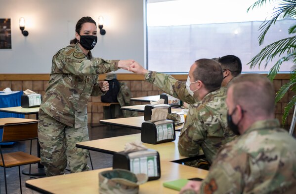 U.S. Air Force Chief Master Sgt. Kristina L. Rogers, 19th Air Force command chief, greets Airmen before the Chief and Senior NCO mentorship lunch on March 29, 2020, in Hangar 97 at Altus Air Force Base, Oklahoma. Rogers answered Airmen’s questions and gave them advice on how to handle crucial conversations. (U.S. Air Force photo by Airman 1st Class Amanda Lovelace)