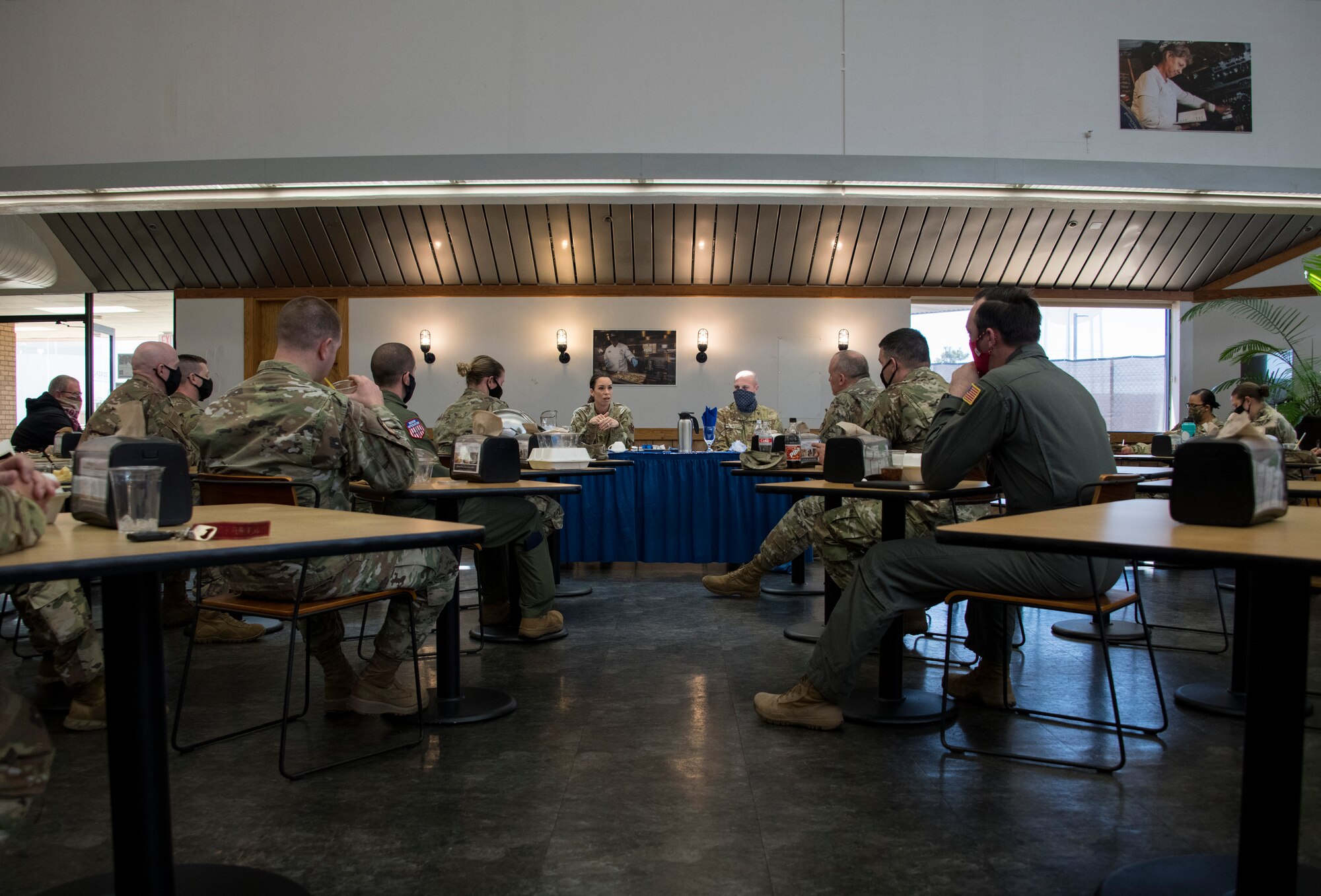 U.S. Air Force Chief Master Sgt. Kristina L. Rogers, 19th Air Force command chief, and Chief Master Sgt. Randy Kay II, 97th Air Mobility Wing command chief, engage with A Chief and Senior NCO during a mentorship lunch on March 29, 2020, in Hangar 97 at Altus Air Force Base, Oklahoma. During the lunch, Rogers spoke about “hot topics” such as the new hair regulations and fitness testing. (U.S. Air Force photo by Airman 1st Class Amanda Lovelace)