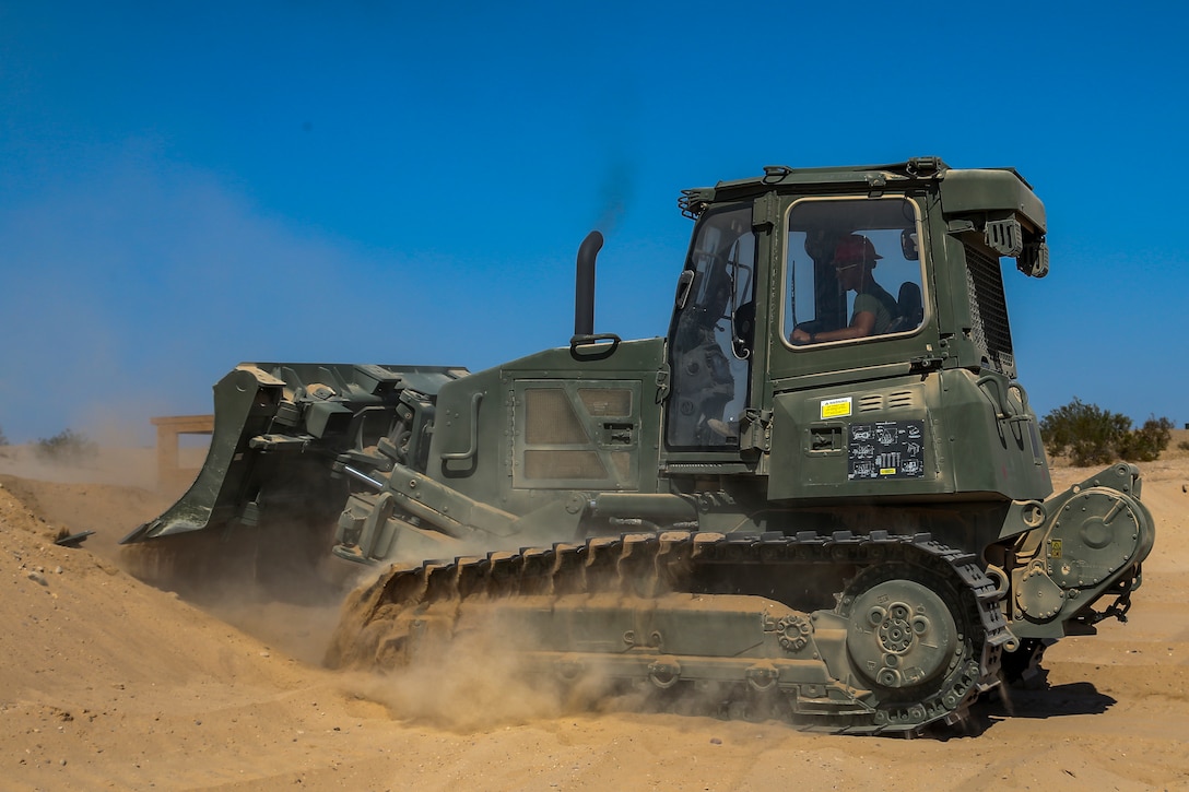U.S. Marine Corps Lance Cpl Edgar Barragan, a heavy equipment operator, with Marine Wing Support Squadron (MWSS) 371, clears dirt for a fuel containment berm to condut fueling operations at Cannon Air Defense Complex, at Yuma, Ariz., October 19, 2020.