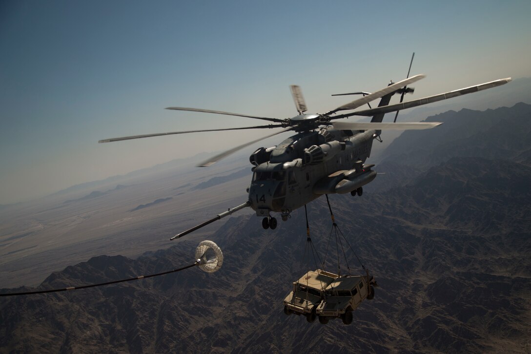 A U.S. Marine Corps CH-53E Super Stallion, assigned to Marine Aviation Weapons and Tactics Squadron One, executes an air to air refuel, during a heavy lift exercise, in support of Weapons and Tactics Instructor course 2-21, near Yuma, Ariz., March 31, 2021. The WTI course is a seven-week training event hosted by MAWTS-1, providing standardized advanced tactical training and certification of unit instructor qualifications to support Marine aviation training and readiness, and assists in developing and employing aviation weapons and tactics.